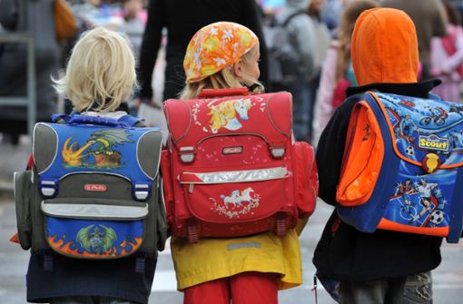 Drei Grundschüler auf dem Weg in ihre Klasse. Ab 2026 sollen Kinder wie sie  und ihre Eltern die Wahl haben, ob sie halb- oder ganztags zur  Schule gehen. Foto: dpa/Patrick Seeger