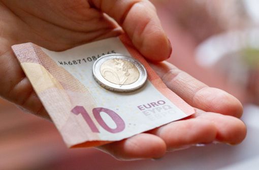 Eine Person hält zwölf  Euro in der Hand:  Das Bundeskabinett bringt  die geplante Erhöhung des Mindestlohns auf zwölf Euro auf den Weg. Foto: dpa/Fernando Gutierrez-Juarez