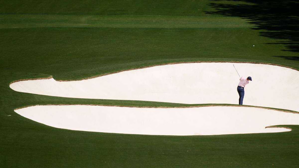 Spannung in der Ferne: Der Golfspieler Rory McIlroy aus Nordirland schlägt am achten Loch. Seit 1934 findet das Golfturnier US Masters auf demselben Golfplatz in Georgia, USA statt.